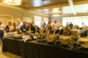 People lining up at a buffet table in a banquet room